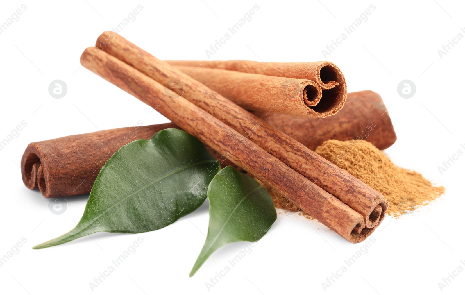 Photo of Dry aromatic cinnamon sticks, powder and green leaves isolated on white