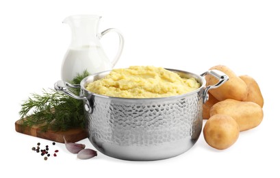 Photo of Pot of tasty mashed potatoes near ingredients on white background