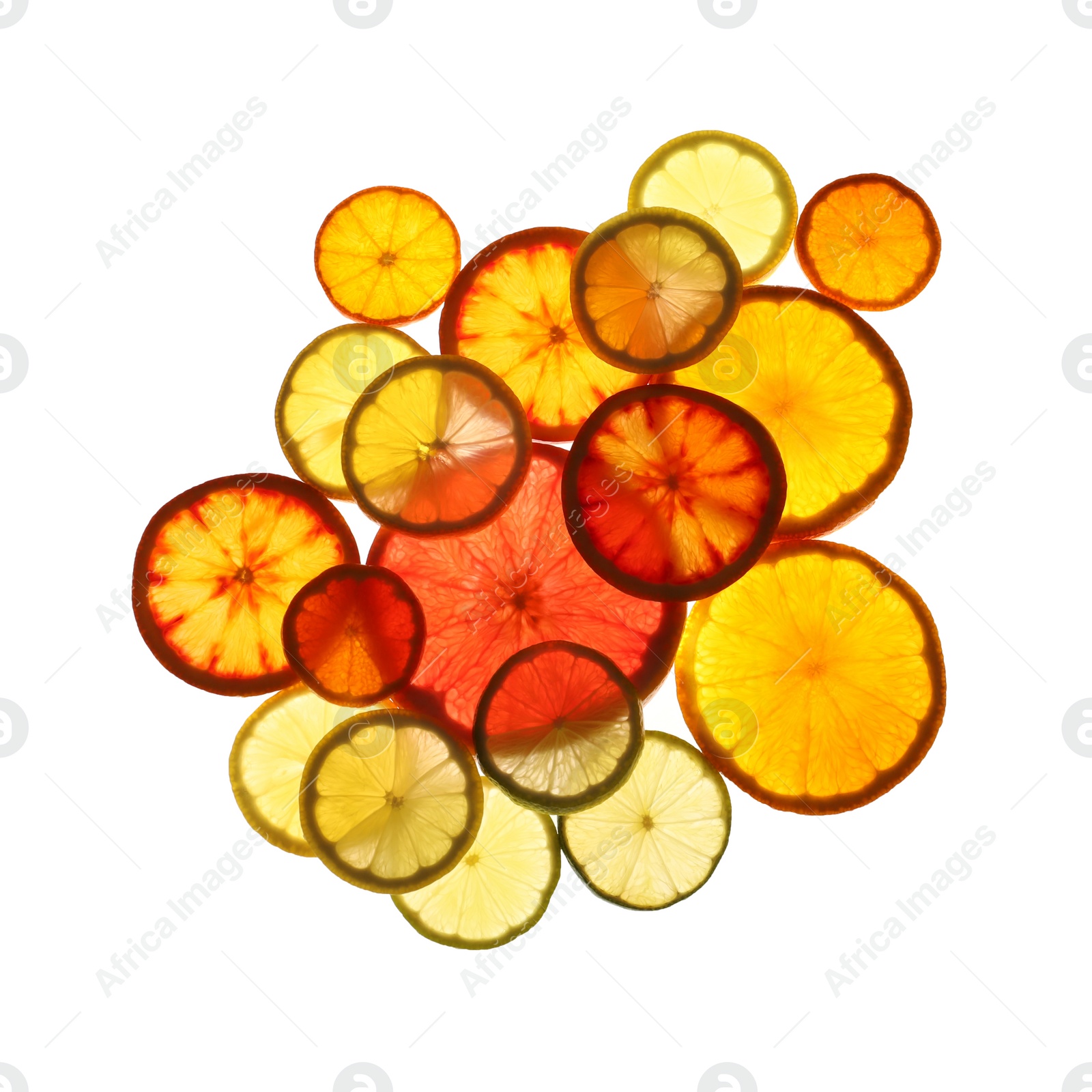 Photo of Illuminated slices of citrus fruits on white background, top view