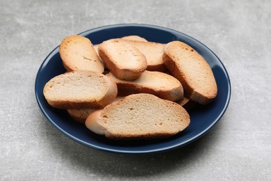 Photo of Plate of hard chuck crackers on light grey table