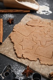 Making Christmas cookies. Raw dough and anise on black table, closeup