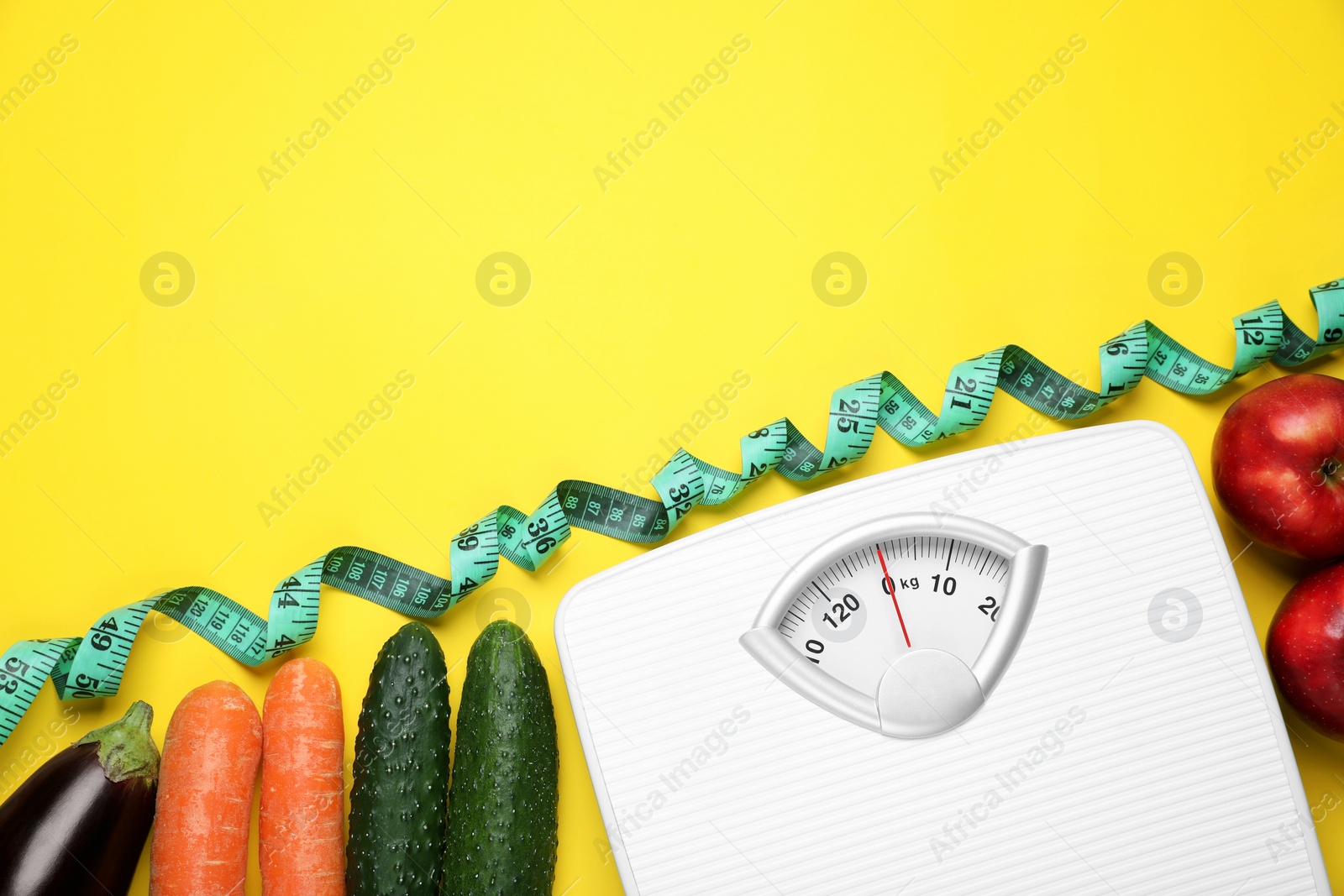 Photo of Scales, measuring tape, fresh vegetables and apples on yellow background, flat lay with space for text. Low glycemic index diet