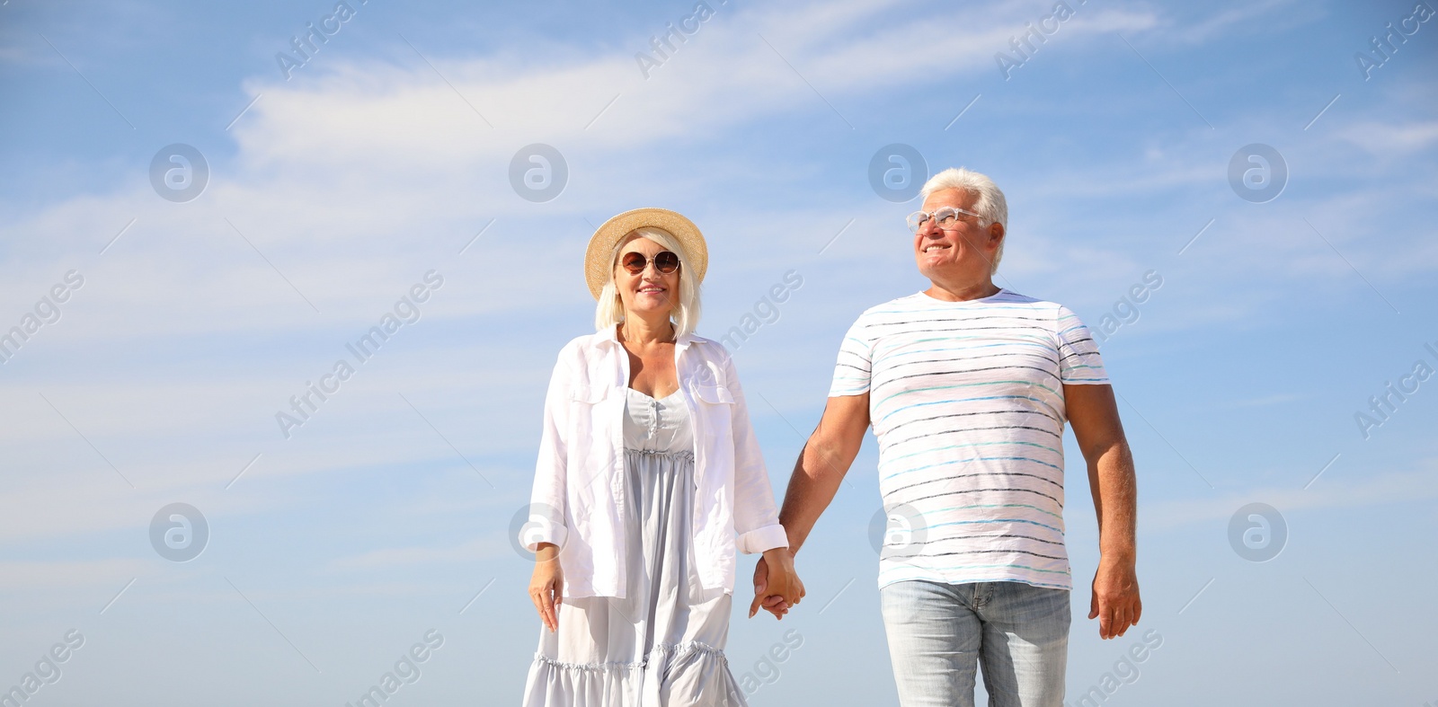 Photo of Mature couple spending time together on sea beach