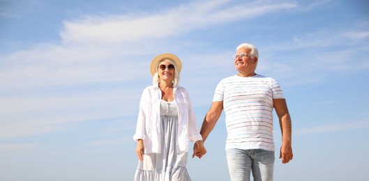 Photo of Mature couple spending time together on sea beach