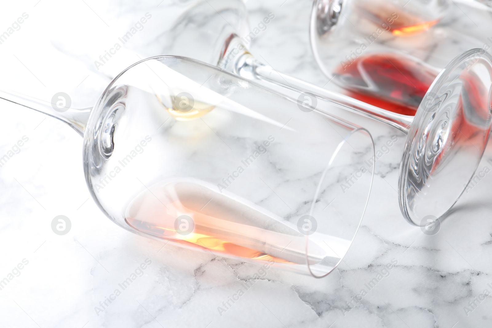 Photo of Glasses with different wine on marble background, closeup