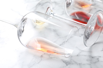 Photo of Glasses with different wine on marble background, closeup