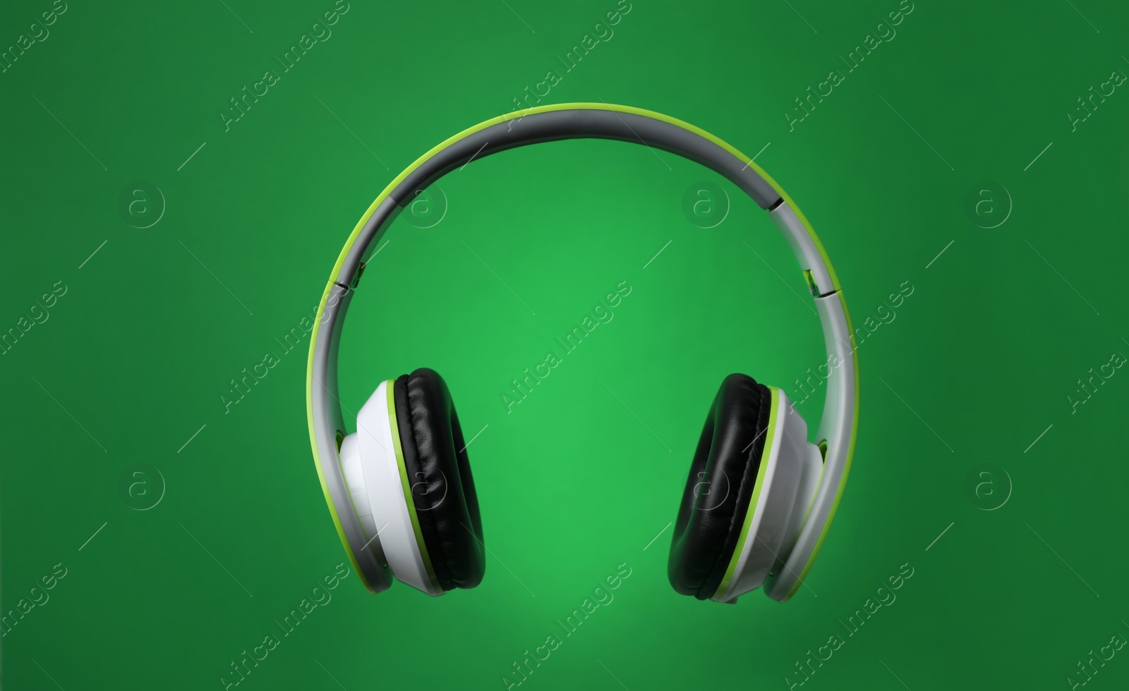 Photo of Stylish modern headphones with earmuffs on color background