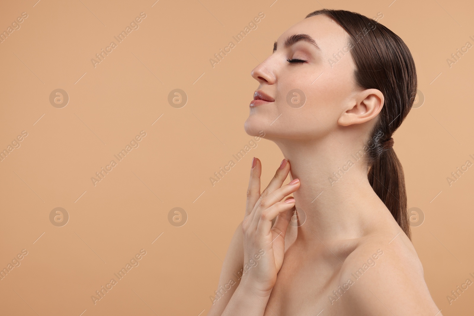 Photo of Beautiful woman touching her neck on beige background. Space for text