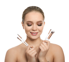 Photo of Beautiful woman with makeup brushes on white background