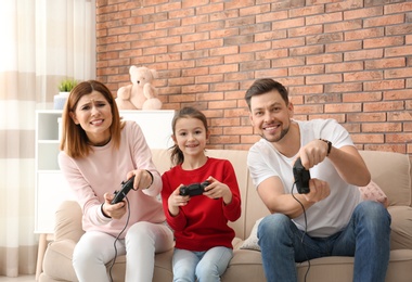 Photo of Happy family playing video games in living room
