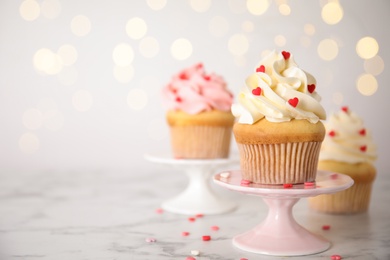 Photo of Tasty sweet cupcake on stand, space for text. Happy Valentine's Day
