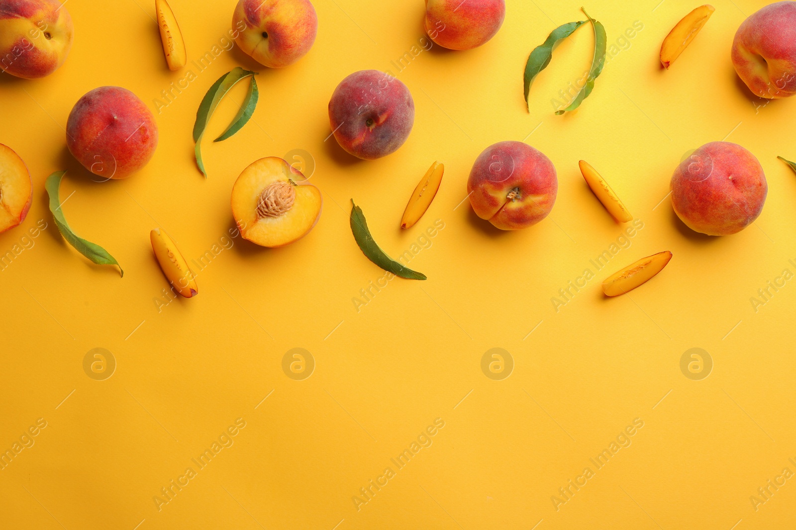 Photo of Flat lay composition with fresh peaches on yellow background. Space for text