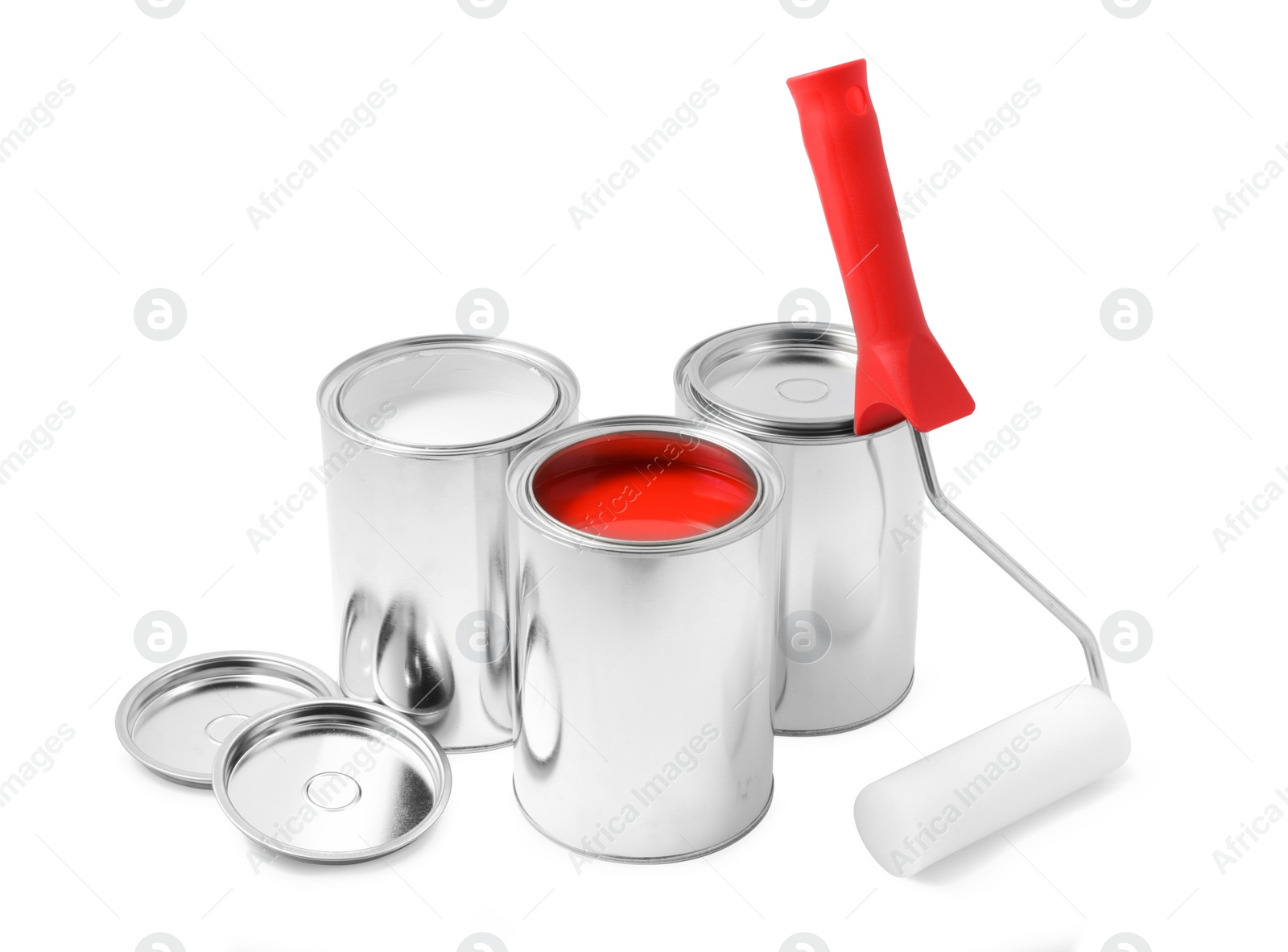 Photo of Cans of color paints and roller on white background