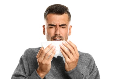 Young man suffering from cold on white background