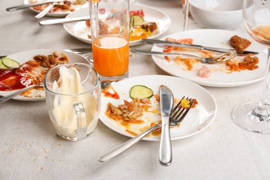 Food leftovers after party on table with cloth