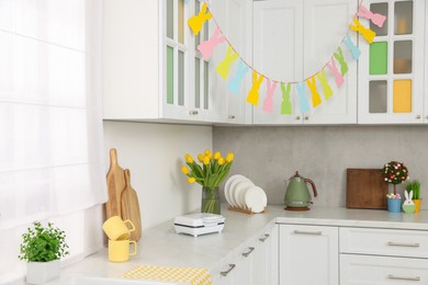 Colorful Easter decor and yellow tulips in kitchen