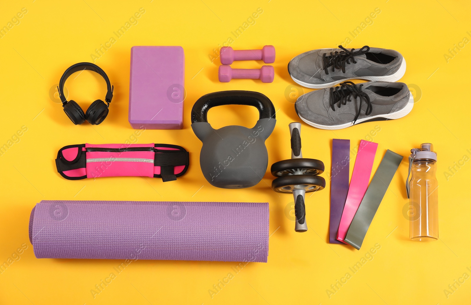 Photo of Different sports equipment on yellow background, flat lay