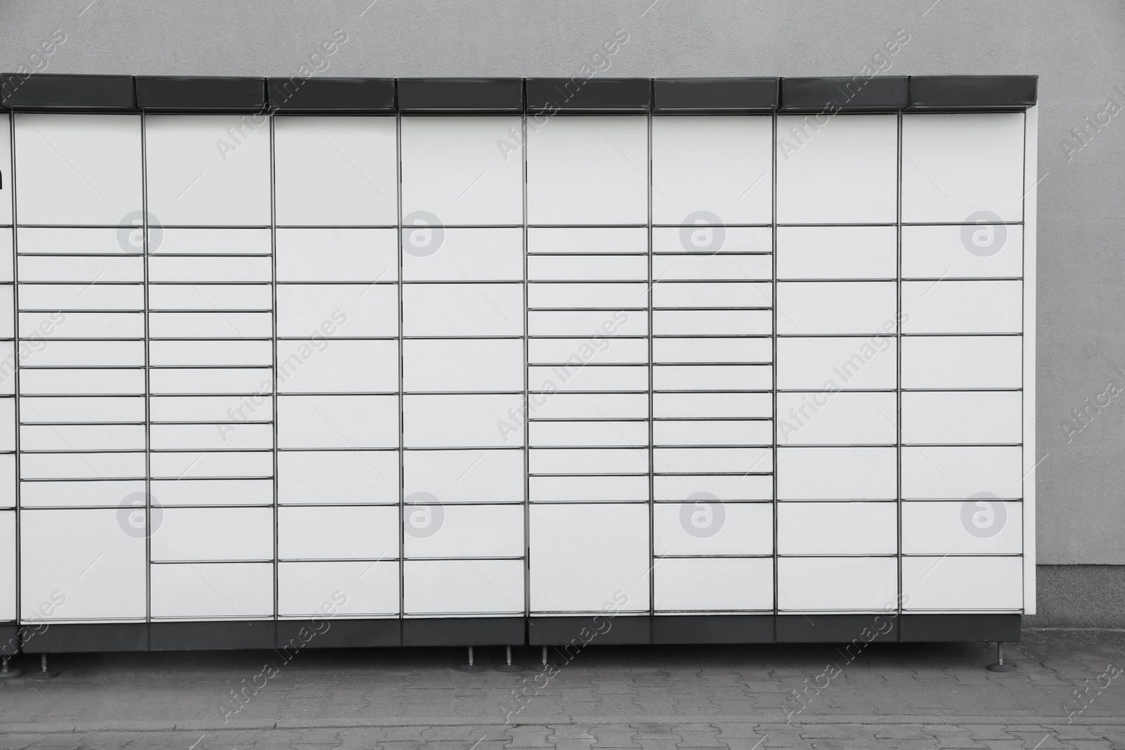 Photo of Modern parcel locker with many postal boxes outdoors