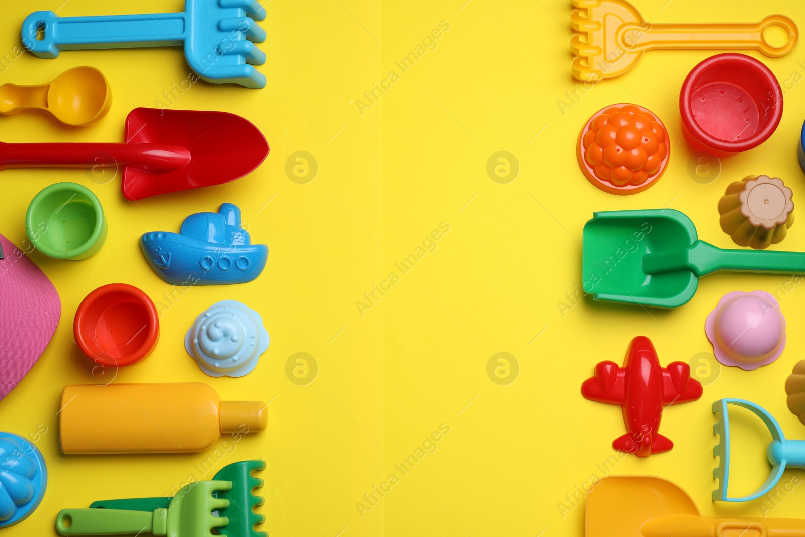 Photo of Beach sand toys on yellow background, flat lay. Space for text