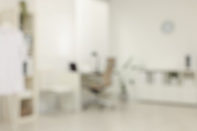 Photo of Blurred view of modern medical office with doctor's workplace in clinic