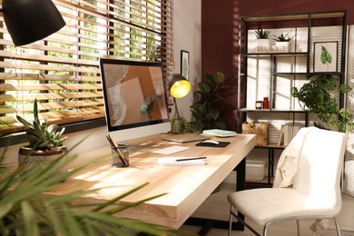 Photo of Light room interior with comfortable workplace near window