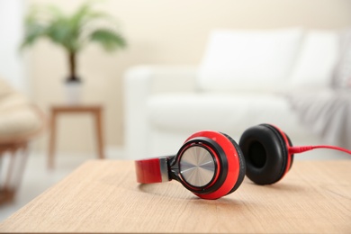 Photo of Stylish headphones on table indoors. Space for text