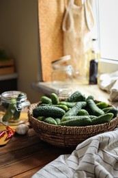 Photo of Fresh cucumbers and other ingredients on wooden table, space for text. Pickling vegetables