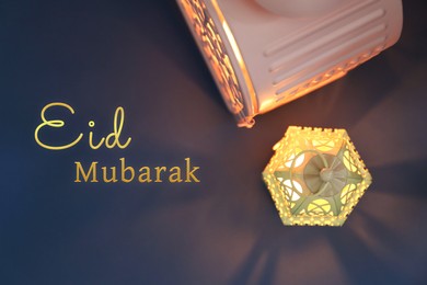 Eid Mubarak greeting card. Arabic lanterns on grey background, flat lay
