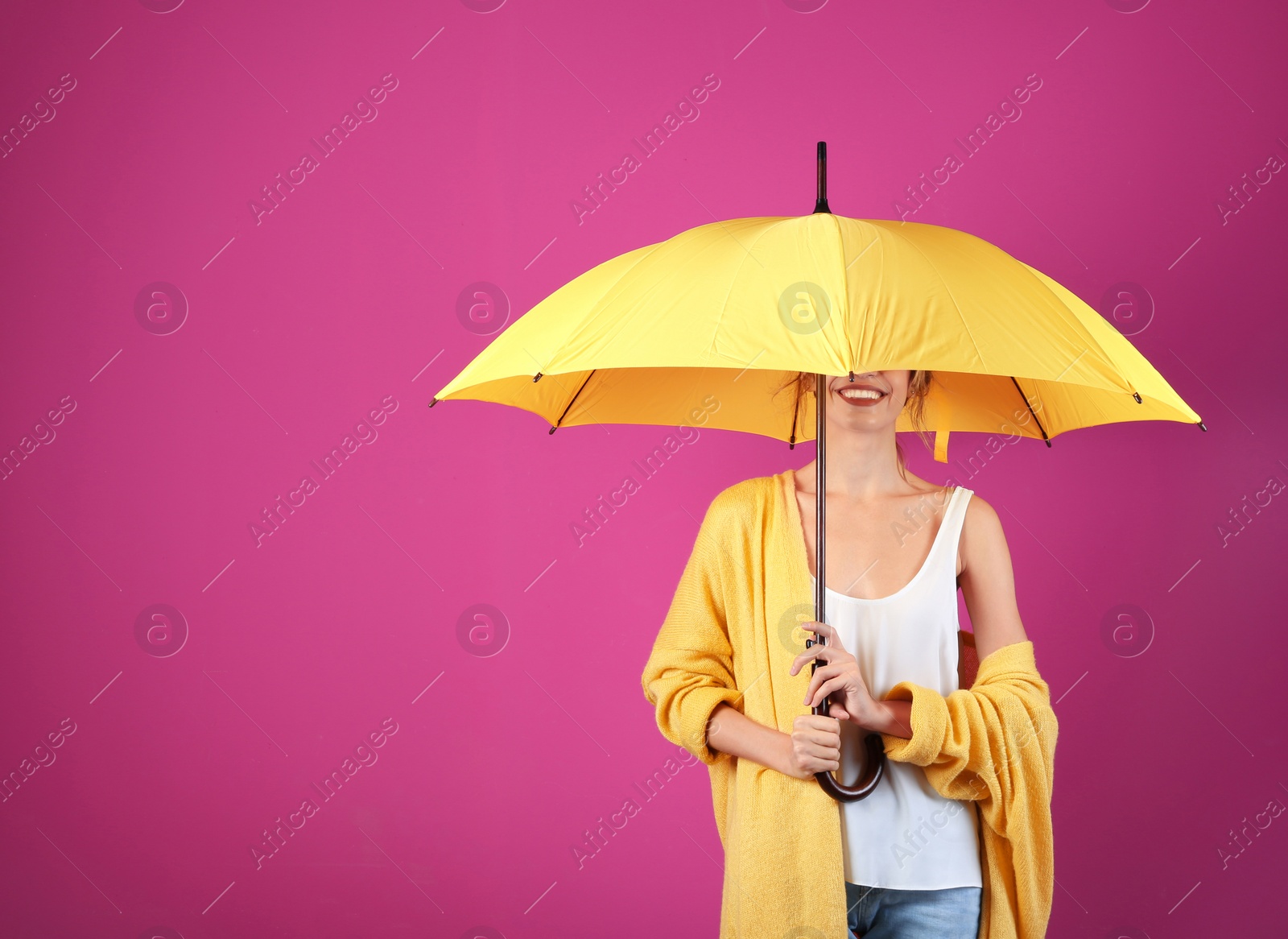 Photo of Woman with yellow umbrella on color background. Space for text