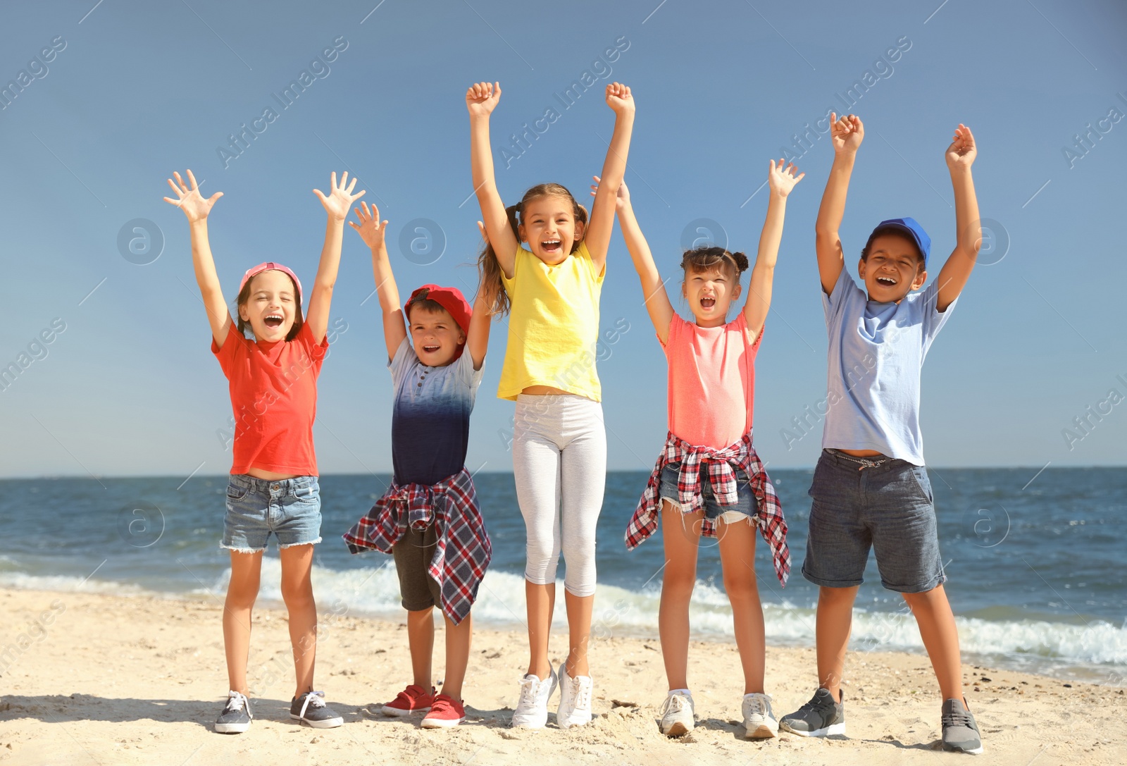 Photo of Group of happy children at sea beach on sunny day. Summer camp