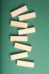 Wooden blocks with word KEYWORDS on green background, flat lay