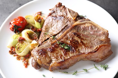 Delicious fried beef meat and vegetables on table, closeup