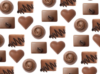 Set with different chocolate candies on white background, top view