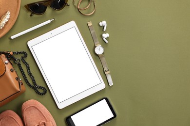 Photo of Flat lay composition with modern tablet on olive background. Space for text