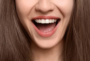 Photo of Young woman with beautiful smile, closeup. Teeth whitening