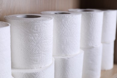 Photo of Stacked toilet paper rolls on shelf, closeup