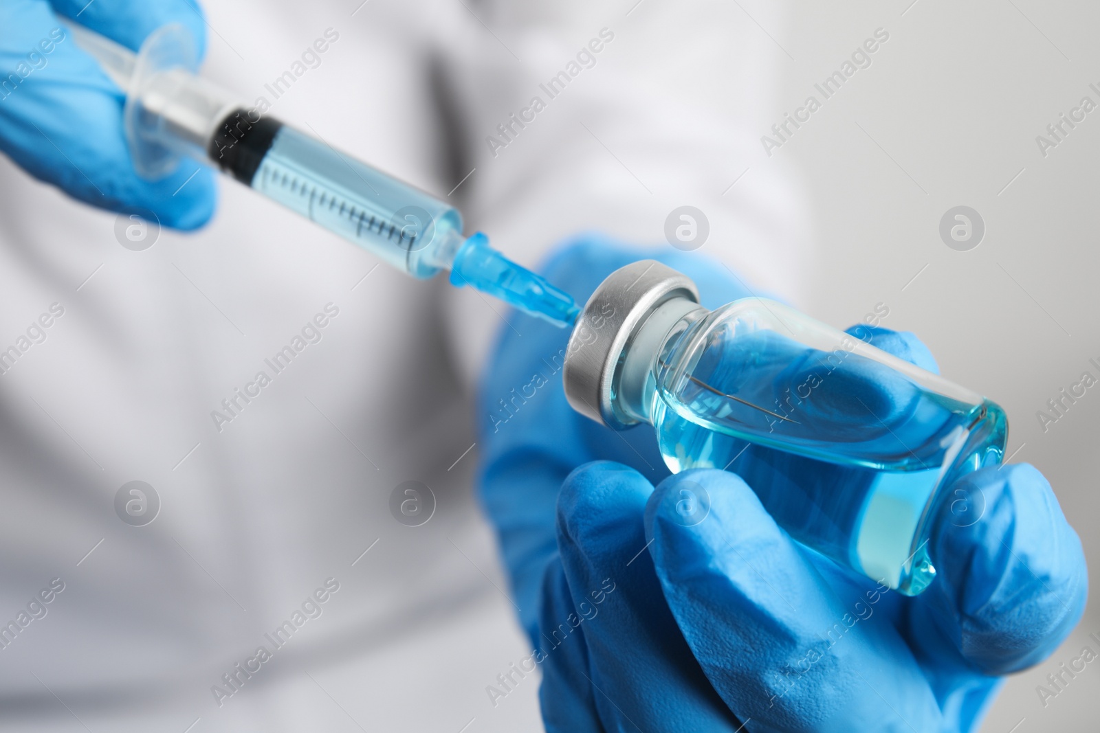 Photo of Doctor filling syringe with medication, closeup. Vaccination and immunization