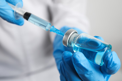 Photo of Doctor filling syringe with medication, closeup. Vaccination and immunization