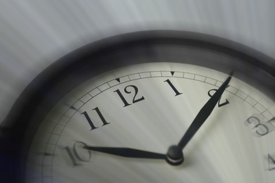 Closeup view of clock, motion blur effect. Time concept