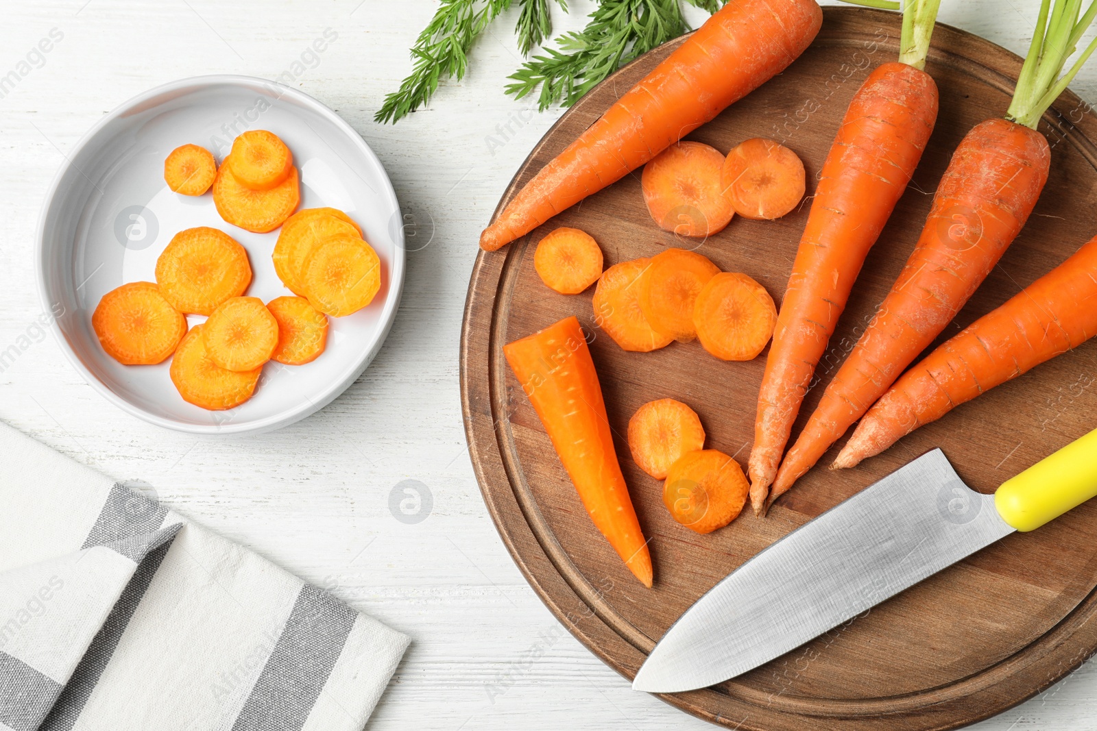 Photo of Flat lay composition with cut carrot on white table