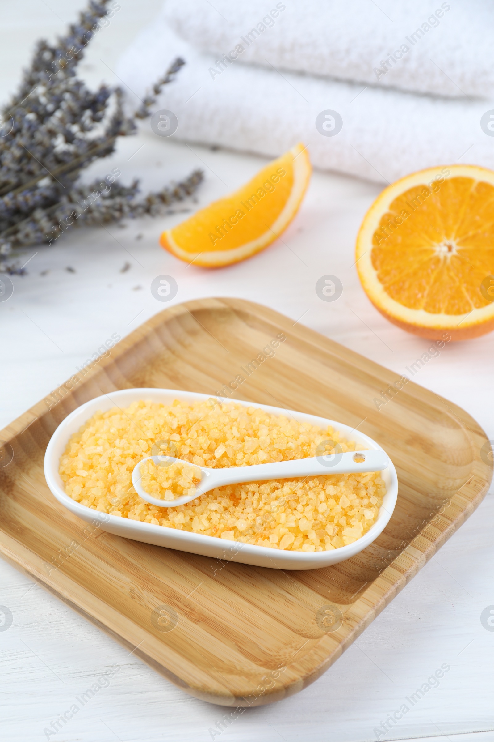 Photo of Sea salt, lavender, orange and towels on white wooden table