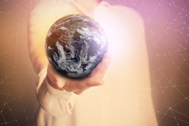 World in our hands. Woman holding digital model of Earth, closeup view 