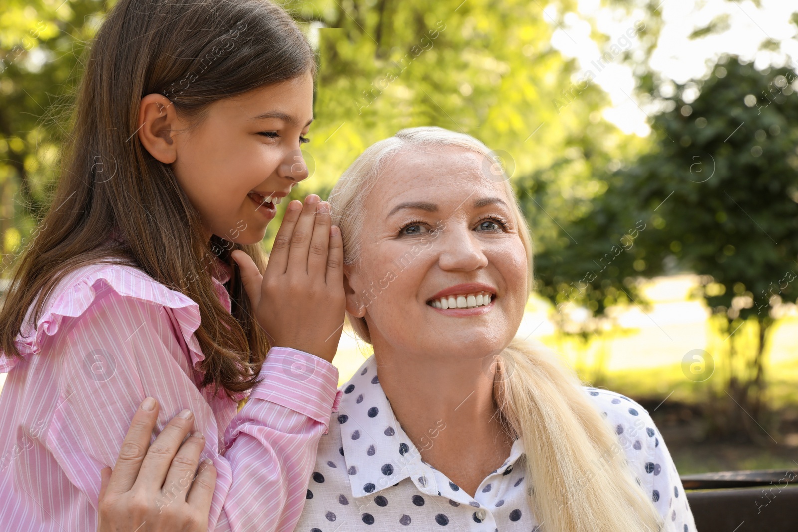 Photo of Mature woman with her little granddaughter in park