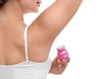 Photo of Young woman applying deodorant to armpit on white background, closeup