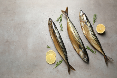 Photo of Tasty smoked fish on light grey table, flat lay. Space for text