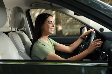 Young woman using navigation system while driving car