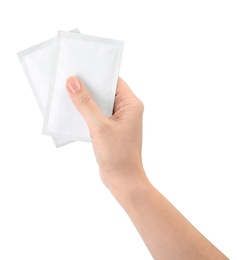 Photo of Woman holding medicine sachets on white background, closeup