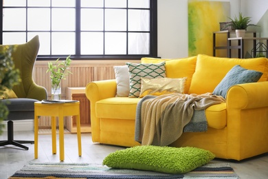 Photo of Stylish living room interior with comfortable sofa and armchair