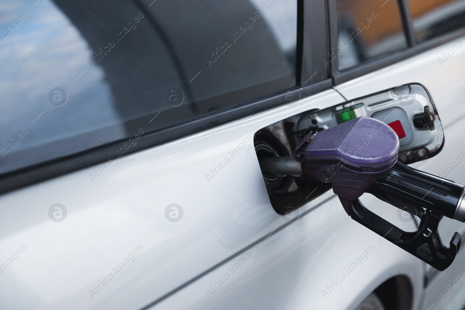 Photo of Refueling modern car at gas filling station, closeup