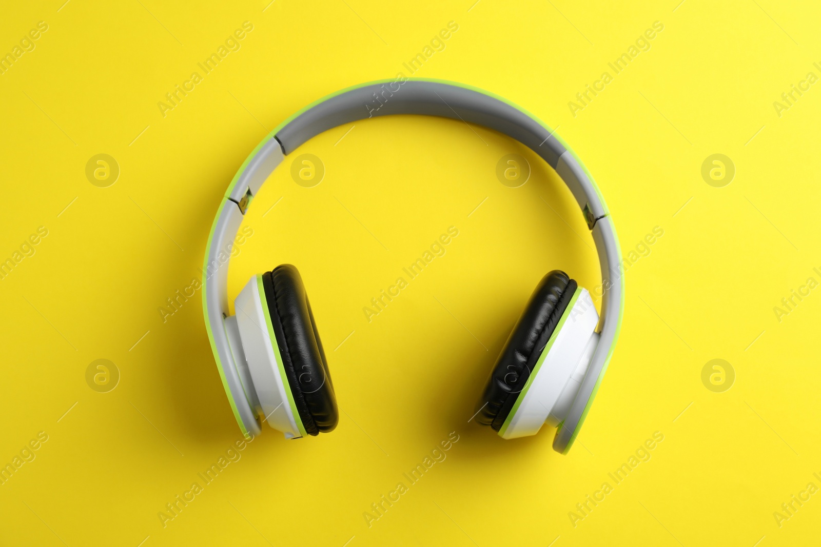 Photo of Wireless headphones on color background, top view